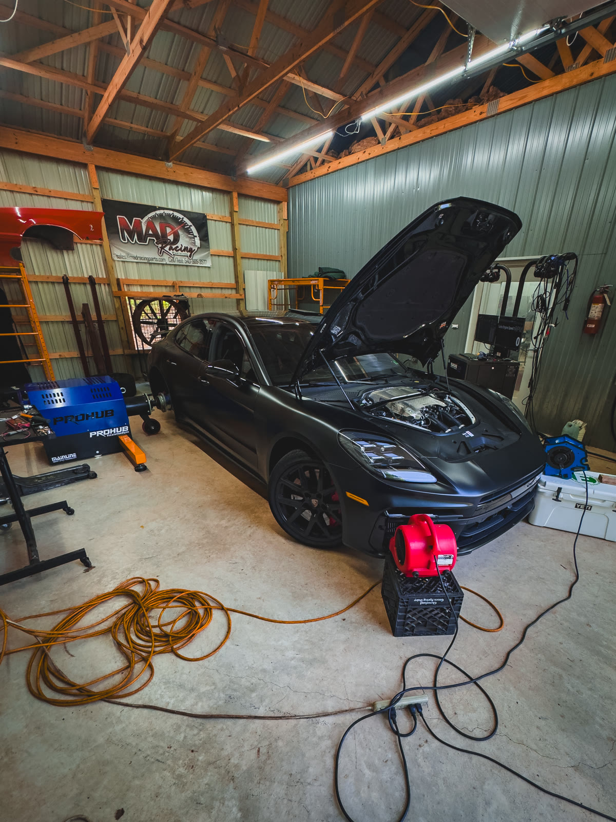Porsche Panamera (976) V8 E-Hybrid with hood open on the hub dyno during PME development